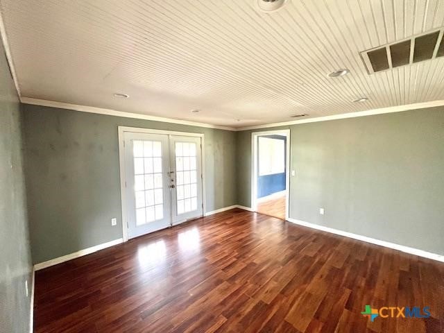 empty room with french doors, wood ceiling, crown molding, and hardwood / wood-style flooring