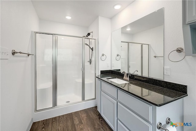 full bathroom with vanity, recessed lighting, wood finished floors, and a stall shower