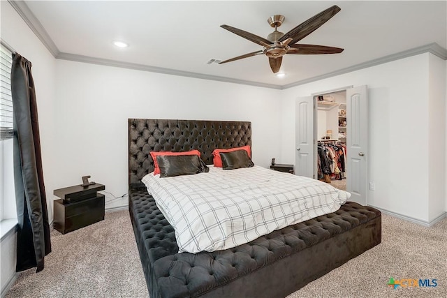 carpeted bedroom featuring crown molding, a walk in closet, recessed lighting, a ceiling fan, and visible vents