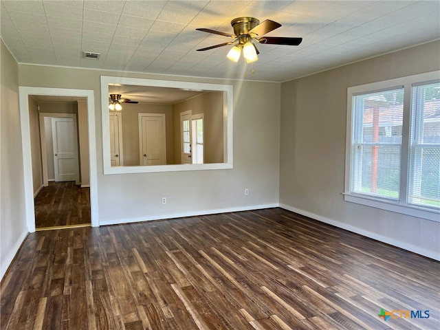 spare room with dark wood-type flooring and ceiling fan