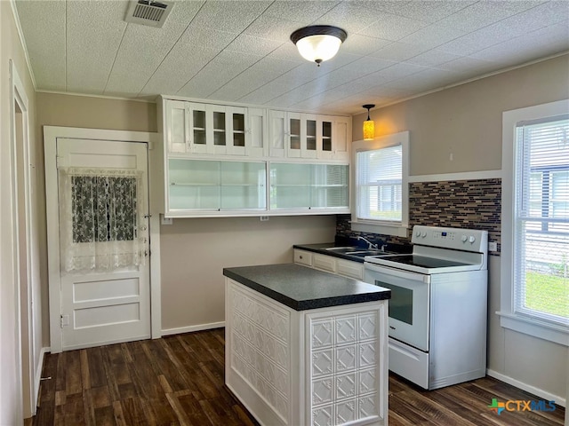 kitchen with hanging light fixtures, white electric range, dark hardwood / wood-style floors, and white cabinets