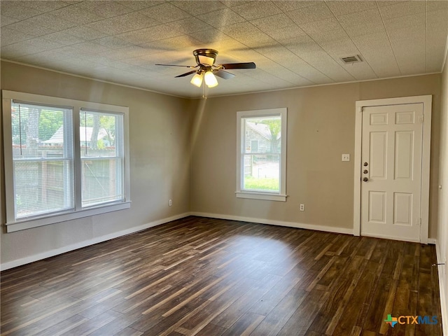 unfurnished room with ceiling fan, dark hardwood / wood-style flooring, and ornamental molding