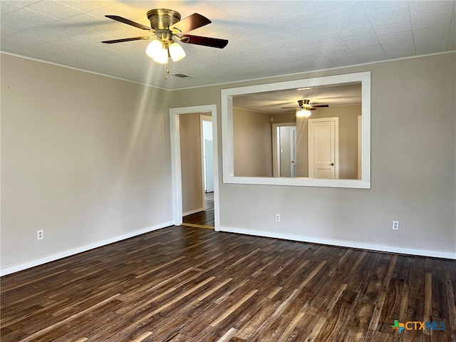 spare room featuring dark wood-type flooring and ceiling fan