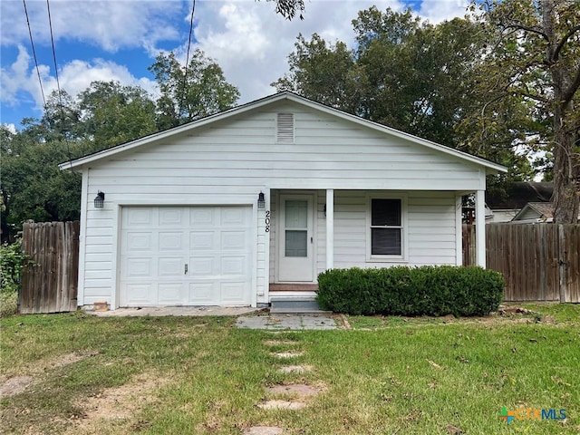 view of front of house featuring a front lawn and a garage