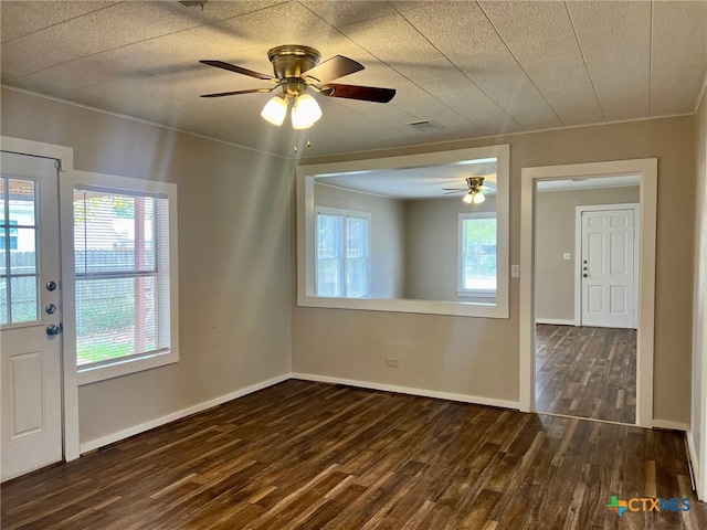 spare room with ceiling fan and dark hardwood / wood-style flooring