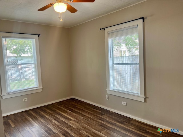 unfurnished room with crown molding, dark hardwood / wood-style flooring, a healthy amount of sunlight, and ceiling fan