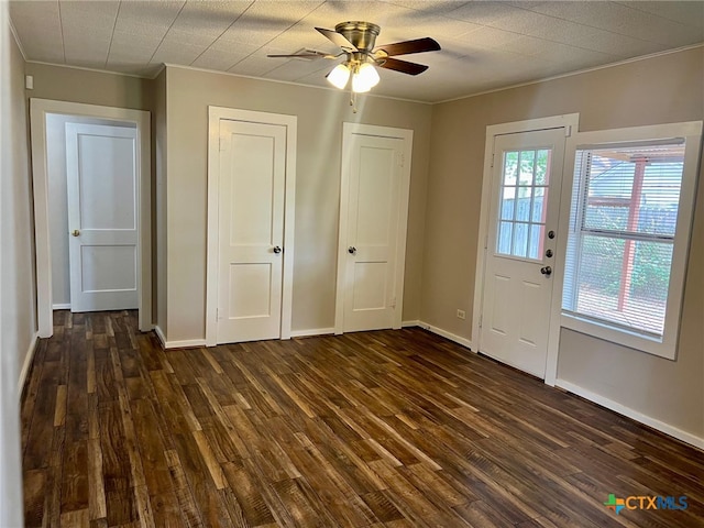 interior space featuring ceiling fan, dark hardwood / wood-style floors, and ornamental molding