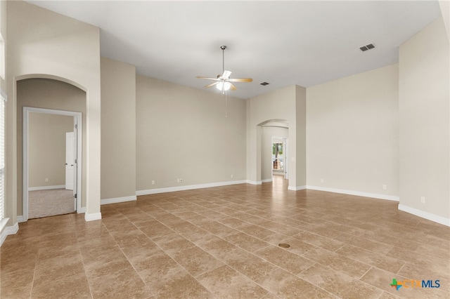 730 Stratus Path, New Braunfels, TX 78130 - spare room featuring arched walkways, ceiling fan, light tile patterned flooring, and baseboards