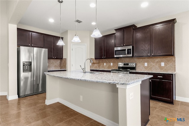 730 Stratus Path, New Braunfels, TX 78130 - kitchen with stainless steel appliances, a sink, dark brown cabinets, a kitchen island with sink, and recessed lighting