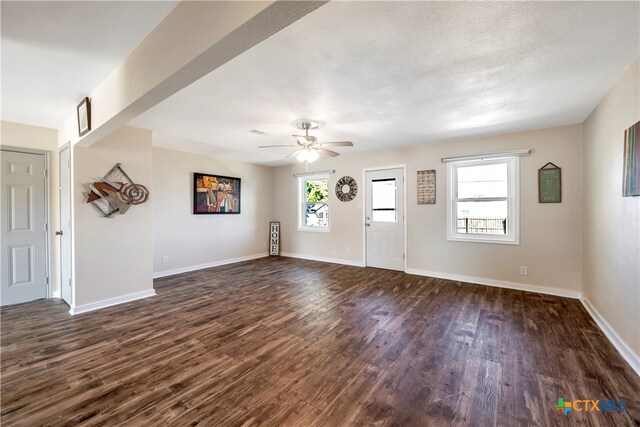 entryway with a textured ceiling, dark hardwood / wood-style flooring, and ceiling fan