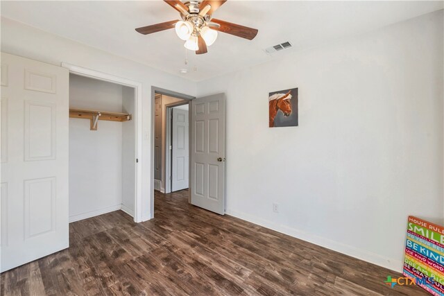 unfurnished bedroom featuring a closet, ceiling fan, and dark hardwood / wood-style flooring