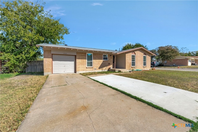 ranch-style house featuring a garage and a front yard