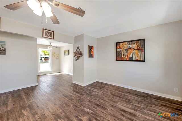 spare room featuring ceiling fan and dark hardwood / wood-style floors