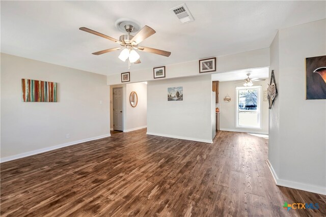 unfurnished living room featuring dark hardwood / wood-style floors and ceiling fan