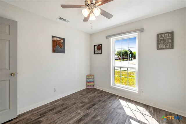 unfurnished room featuring ceiling fan and dark wood-type flooring