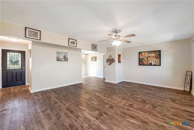 unfurnished living room with dark hardwood / wood-style floors and ceiling fan