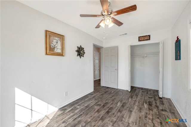 unfurnished bedroom with a closet, ceiling fan, and dark hardwood / wood-style floors