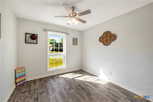 empty room with ceiling fan and wood-type flooring