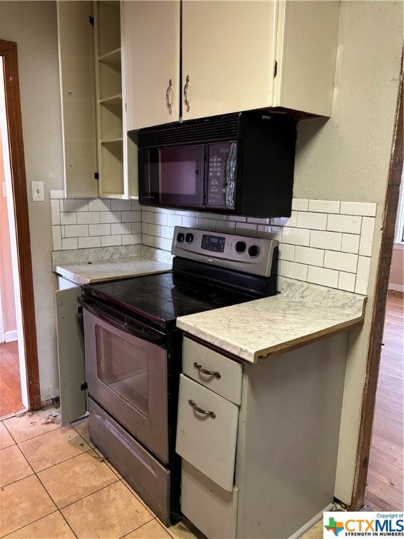 kitchen featuring range with electric stovetop, light wood-type flooring, and backsplash