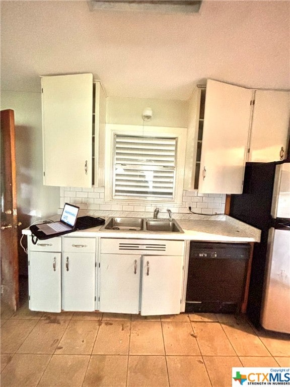 kitchen with white cabinets, sink, dishwasher, and light tile patterned flooring