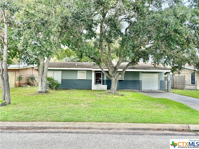 single story home featuring a garage and a front lawn