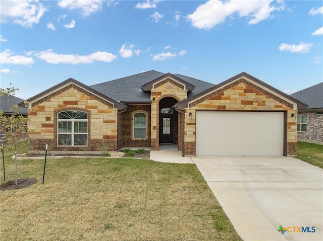 view of front of home featuring a garage and a front lawn