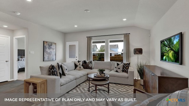 living room with hardwood / wood-style floors and vaulted ceiling