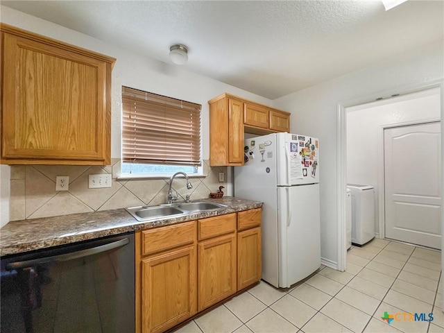 408 Rowdy Dr, Killeen, TX 76542 - kitchen featuring dishwasher, washer / clothes dryer, freestanding refrigerator, dark countertops, and light tile patterned flooring