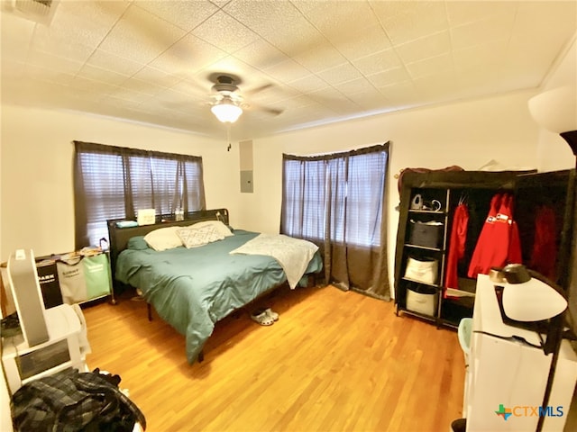 bedroom with ceiling fan and wood-type flooring