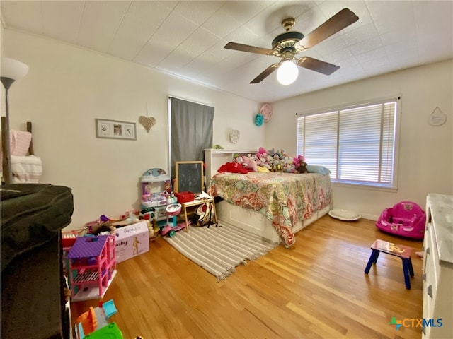 bedroom featuring ceiling fan and light hardwood / wood-style floors