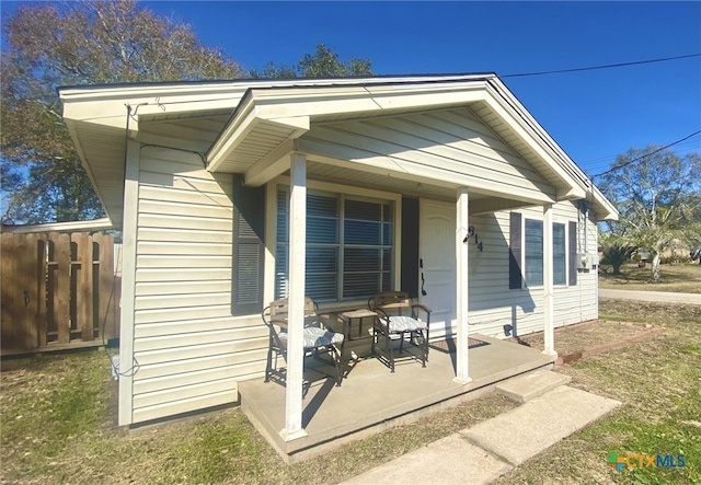 back of house featuring covered porch