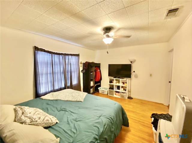 bedroom with ceiling fan and hardwood / wood-style floors