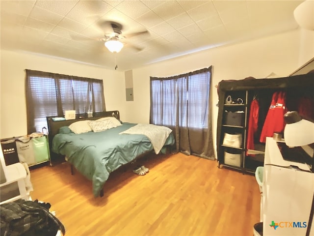 bedroom with ceiling fan and hardwood / wood-style flooring