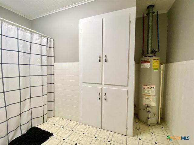 bathroom featuring ornamental molding, gas water heater, and tile walls