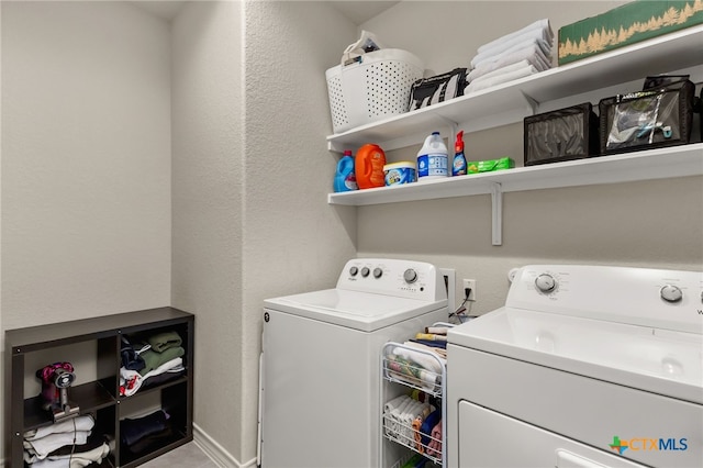 135 Mary Max Cir, San Marcos, TX 78666 - clothes washing area with washer and clothes dryer and a textured wall