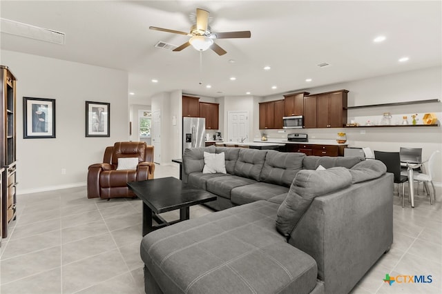 135 Mary Max Cir, San Marcos, TX 78666 - living room with light tile patterned floors, ceiling fan, recessed lighting, and baseboards