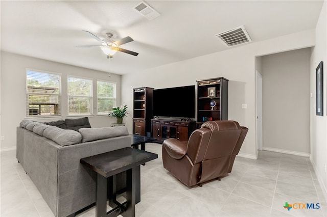 135 Mary Max Cir, San Marcos, TX 78666 - living room with ceiling fan, light tile patterned flooring, and baseboards