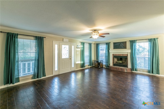 unfurnished living room featuring a wealth of natural light, dark hardwood / wood-style floors, and ornamental molding