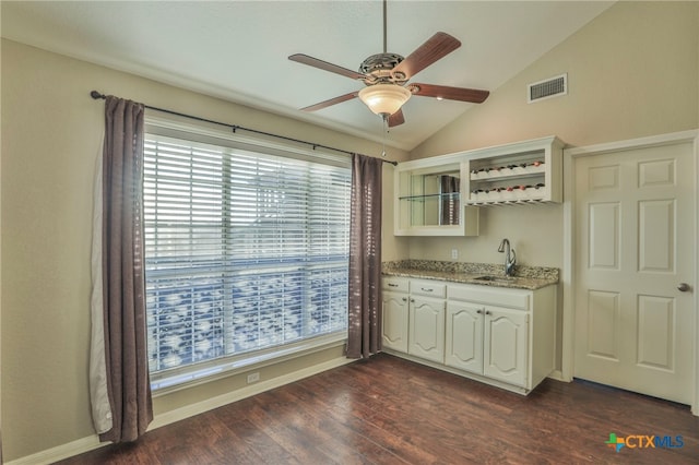 kitchen featuring sink, white cabinets, dark wood-type flooring, lofted ceiling, and ceiling fan