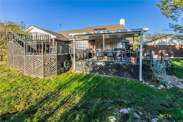 rear view of property featuring a deck