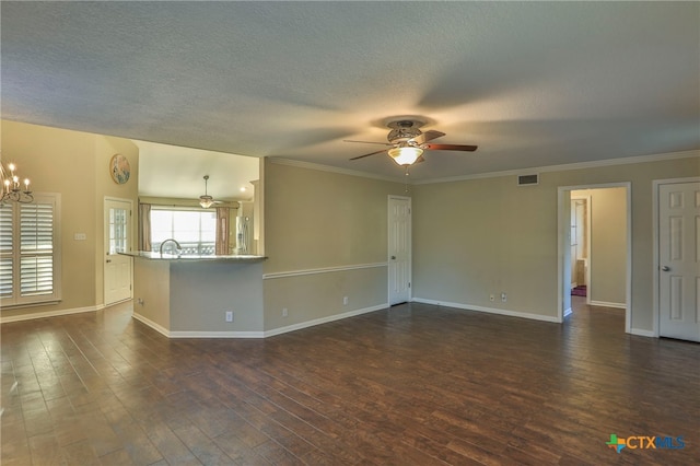 unfurnished living room featuring dark hardwood / wood-style flooring, a textured ceiling, ornamental molding, and ceiling fan with notable chandelier