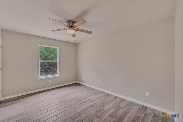 1139 Persimmon Pass, Fischer, TX 78623 - empty room featuring a ceiling fan, wood finished floors, and baseboards