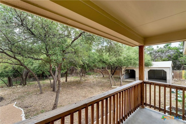 1139 Persimmon Pass, Fischer, TX 78623 - deck featuring an outbuilding and view of wooded area