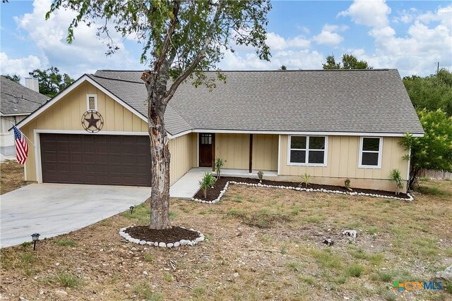 1139 Persimmon Pass, Fischer, TX 78623 - ranch-style home with roof with shingles, an attached garage, concrete driveway, and board and batten siding