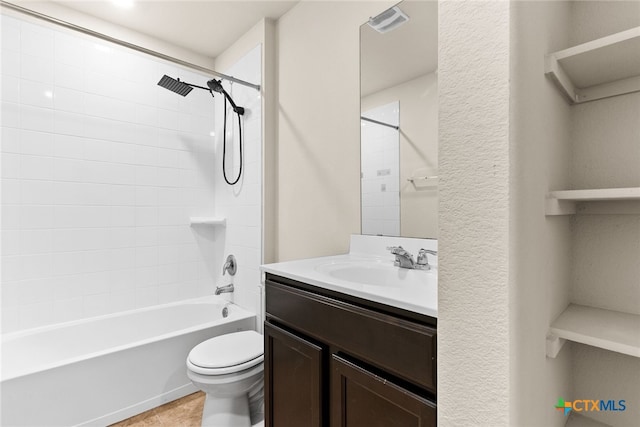 full bathroom with tile patterned flooring, toilet, vanity, and tiled shower / bath