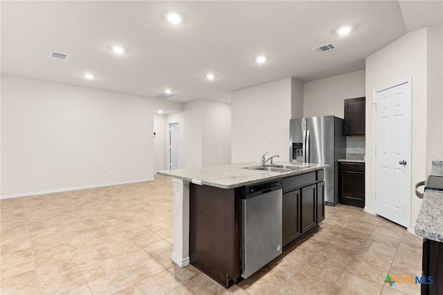 kitchen with sink, stainless steel appliances, dark brown cabinetry, and an island with sink