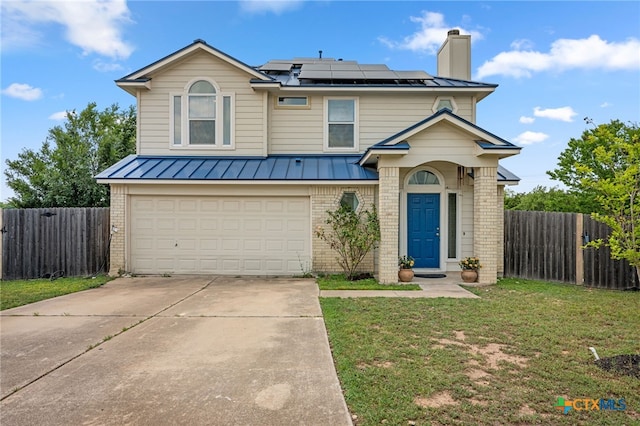 907 Pecos Cv, Leander, TX 78641 - traditional home featuring brick siding, a standing seam roof, an attached garage, and solar panels