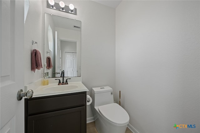 907 Pecos Cv, Leander, TX 78641 - half bath with toilet, vanity, and baseboards