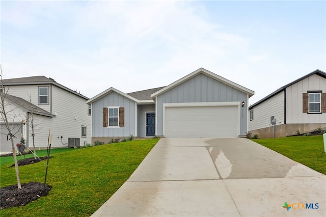 view of front facade featuring a front yard, a garage, and cooling unit