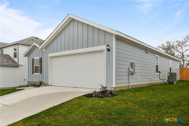 view of front of home with central AC, a front lawn, and a garage